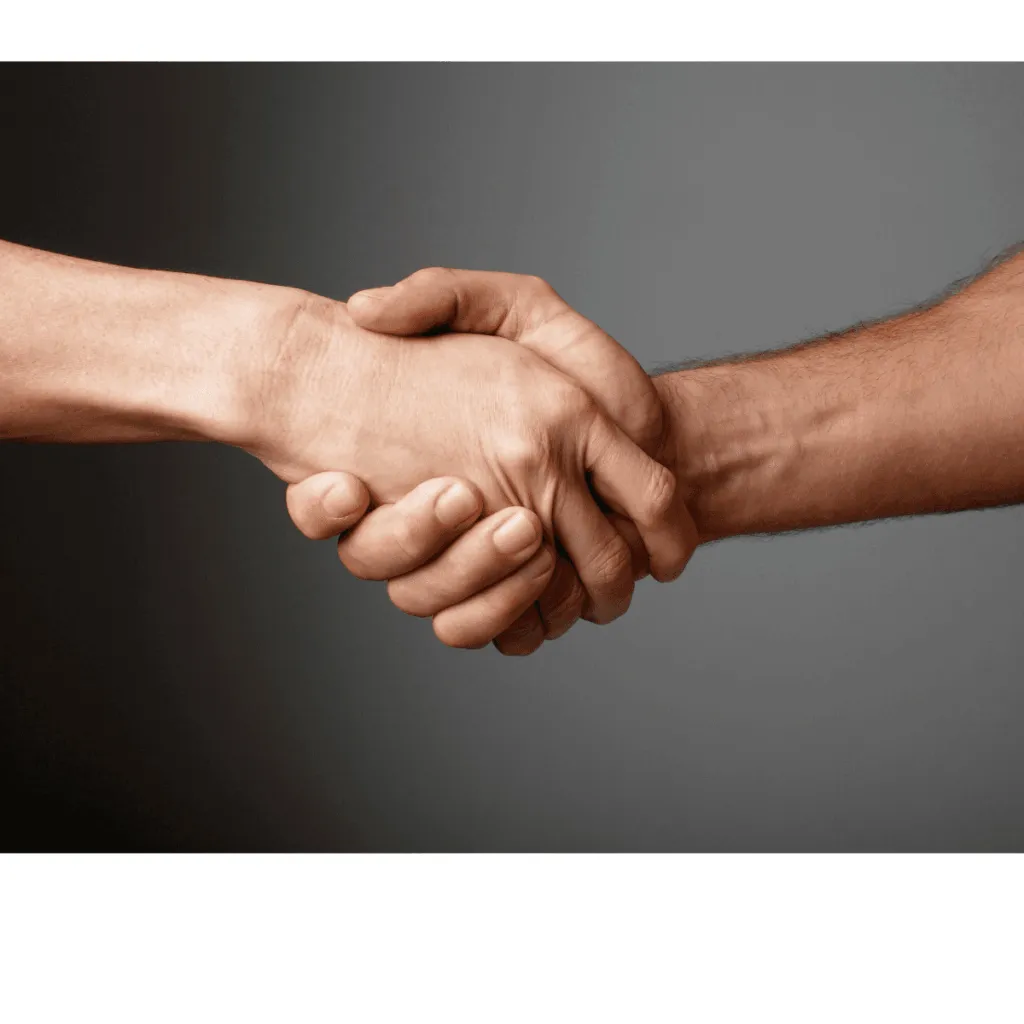 Two hands are shaking in a gesture of agreement or partnership against a neutral background.
