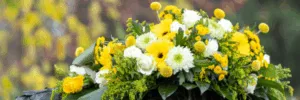 A floral arrangement featuring yellow and white flowers is displayed prominently.