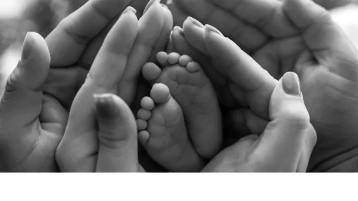 Hands gently cradle a small baby foot, emphasizing care and protection.